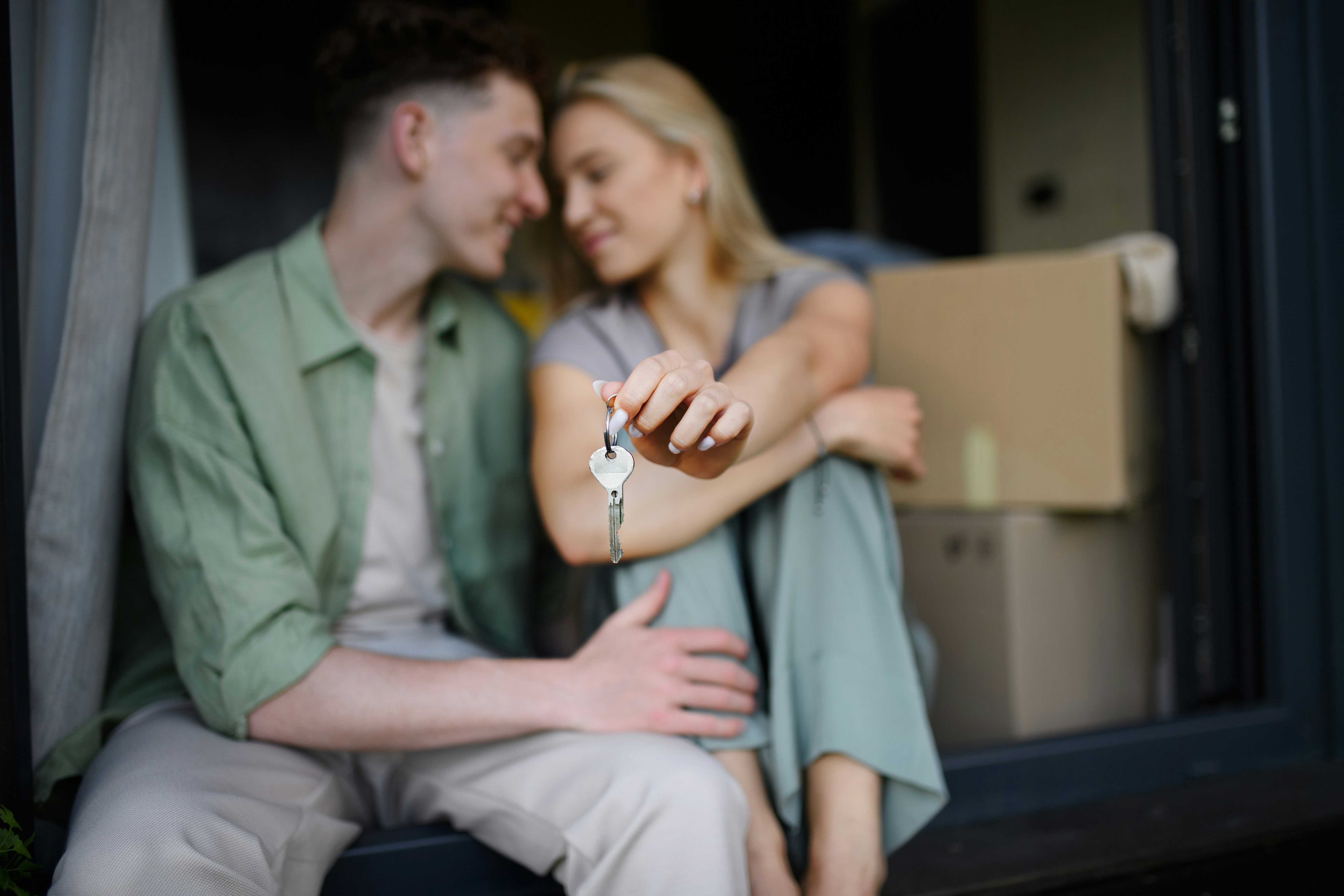Couple showing keys on moving day