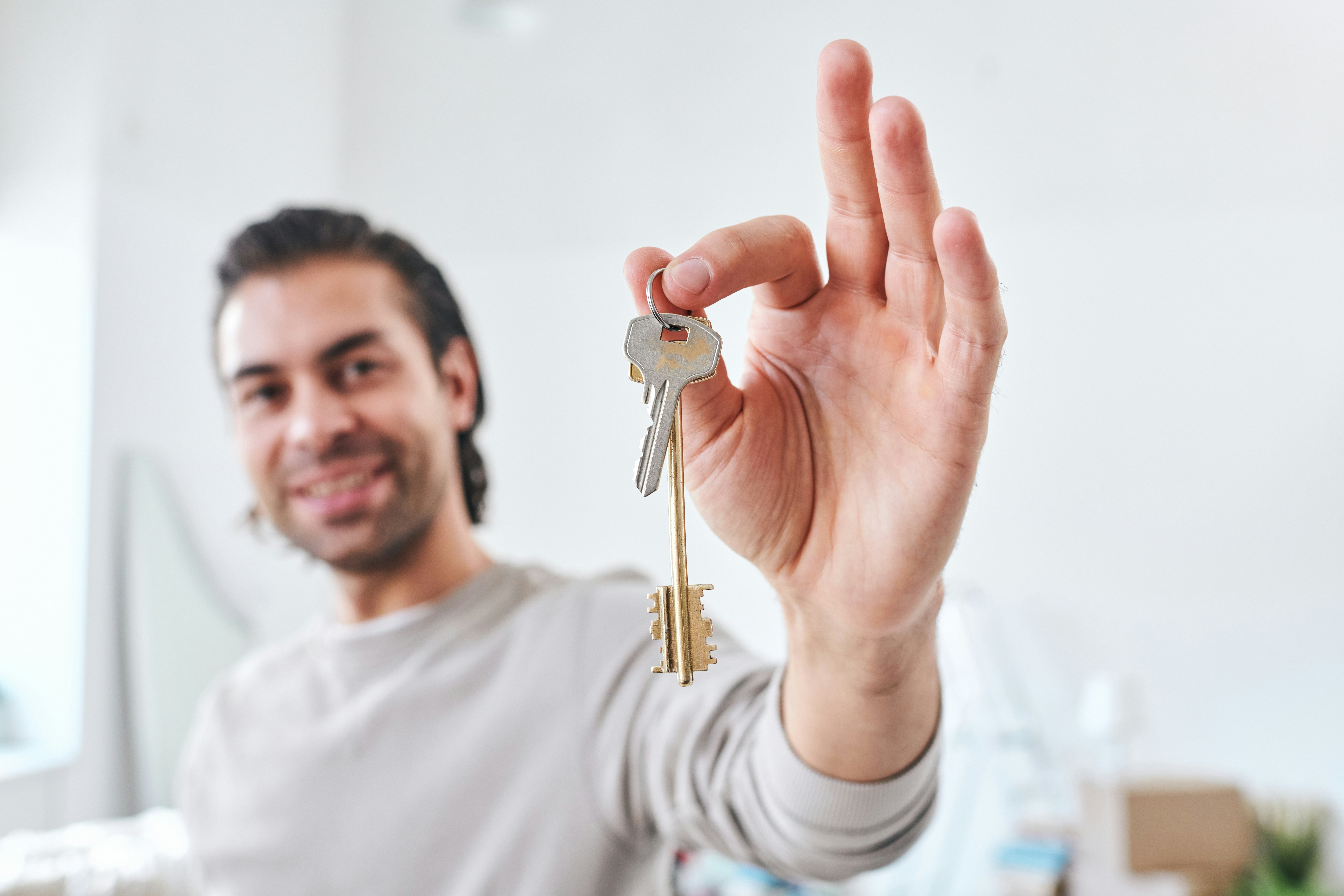 Man holding up an apartment key
