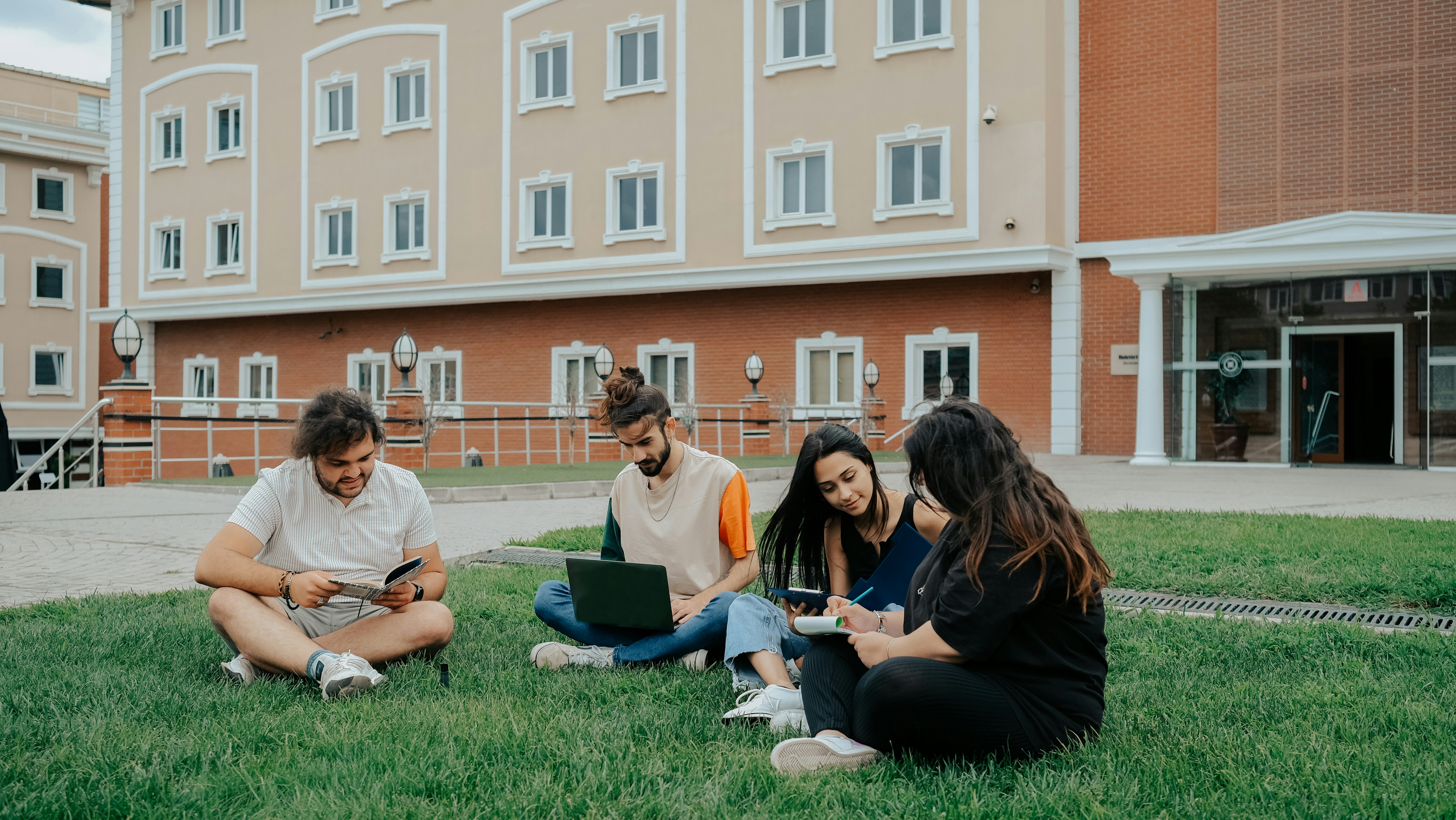 Students studying on a campus lawn in Utrecht